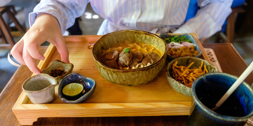 Person eating Khao Soi