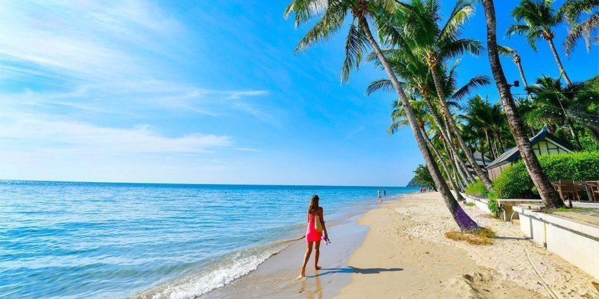 Woman walking on the beach on Koh Chang in Thailand