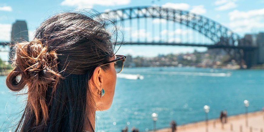Woman looking at the Sydney Harbour Bridge in Sydney, Australia
