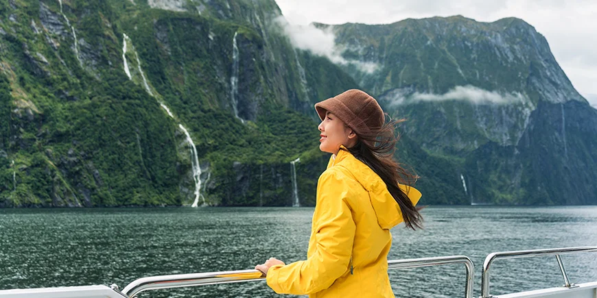 Woman sailing in Milford Sound, New Zealand