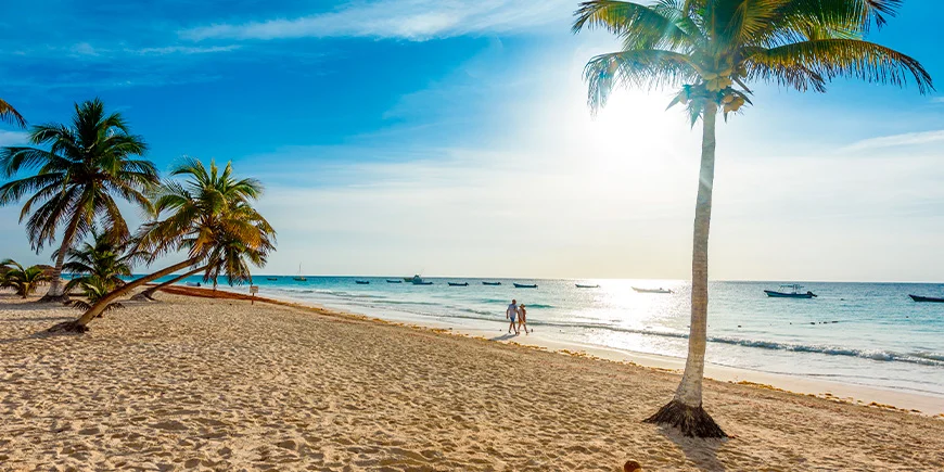 Couple walking on Playa Paraiso near Tulum in Mexico
