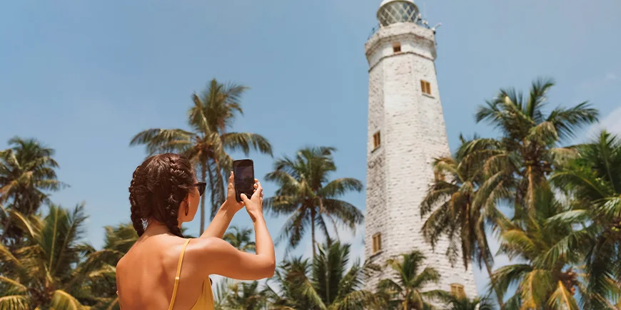 Girl taking a photo at the lighthouse in Galle, Sri Lanka